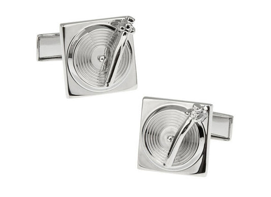 Silver cufflinks designed like turntables on a white background