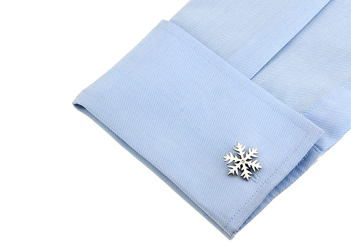 Light blue dress shirt with a snowflake cufflink on a white background