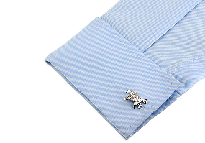 Silver cufflink on a light blue shirt