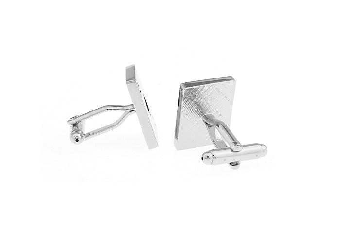 Silver cufflinks on a white background