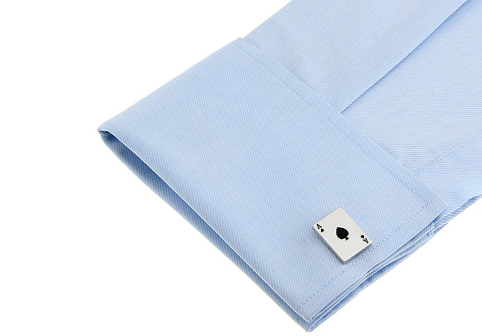 Cufflink on a light blue shirt with a white background