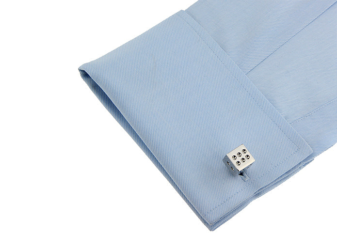 Light blue pocket square with a silver dice-shaped cufflink on a white background