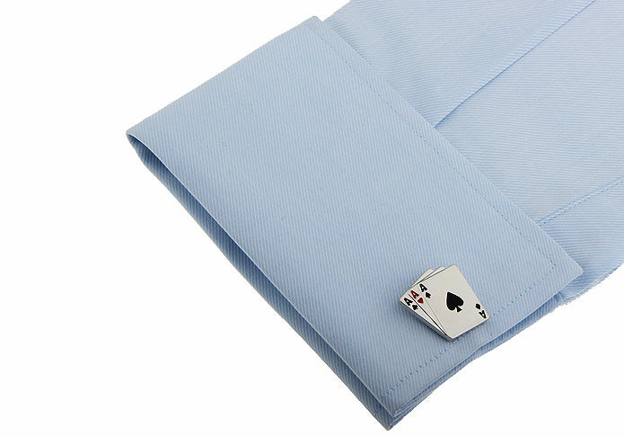 Silver spade card cufflink on a light blue shirt