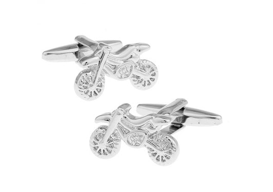 Silver bike-shaped cufflinks on a white background