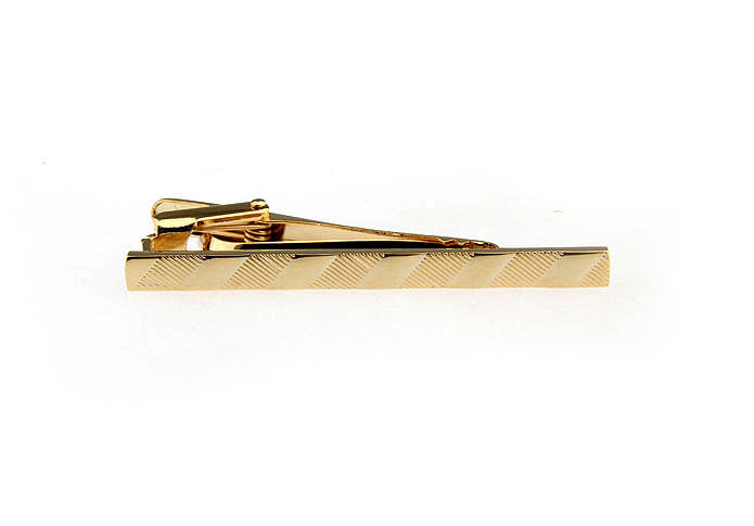 Gold tie clip on a white background
