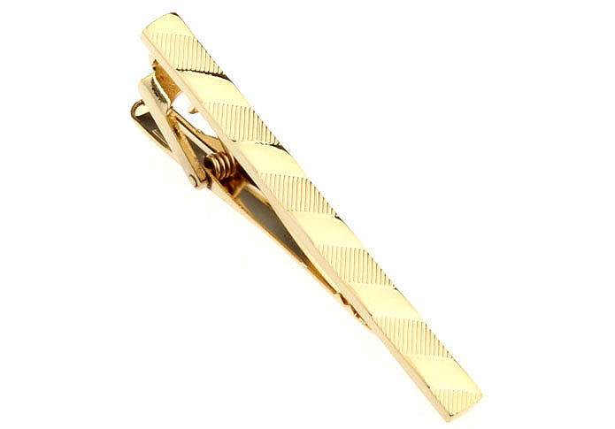 Gold tie clip on a white background