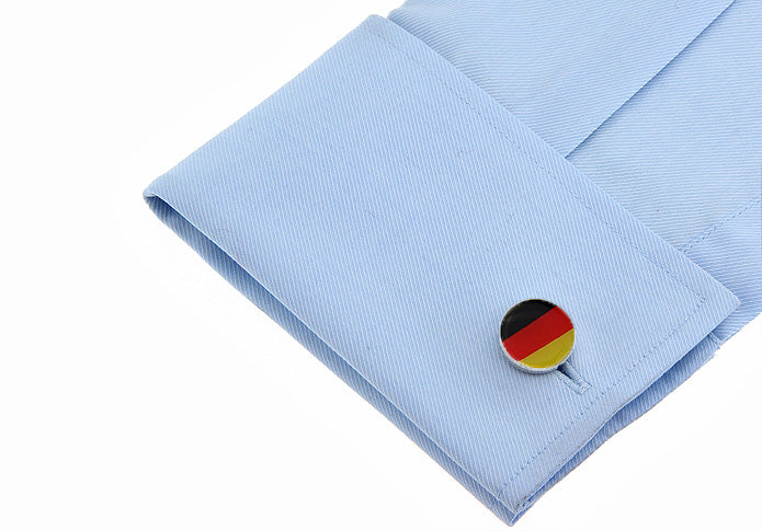 Cufflink with German flag design on a light blue shirt cuff