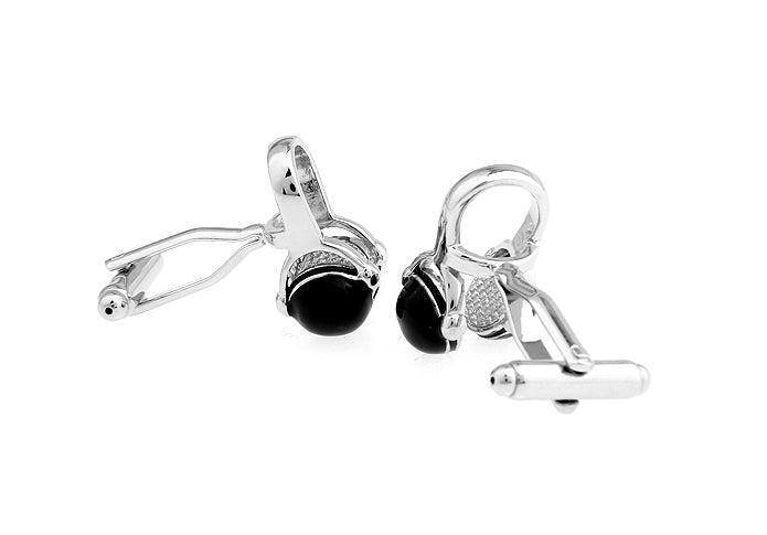 Silver cufflinks with black gemstones on a white background