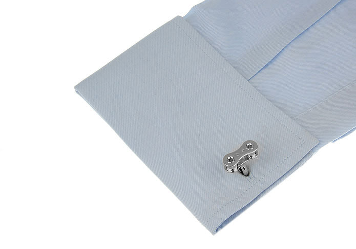 Light blue pocket square with a silver cufflink on a white background