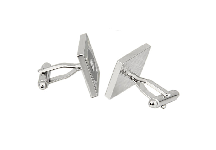 Silver geometric cufflinks on a white background