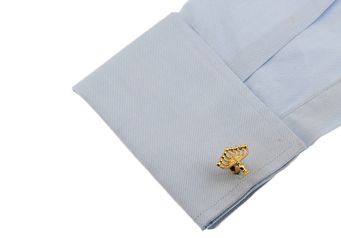 Gold Menorah cufflinks on a white background