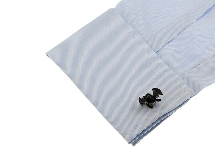 Black cufflink on a light blue shirt cuff