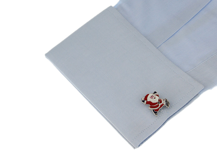 Cufflink with Santa Claus design on a light blue shirt cuff