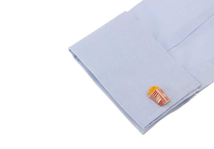Light blue dress shirt with a colorful pop corn cufflink on a white background