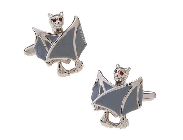 Bat-shaped cufflinks with gray wings and red eyes on a white background