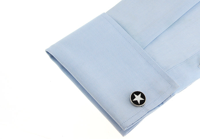 Light blue shirt cuff with a star-shaped cufflink on a white background