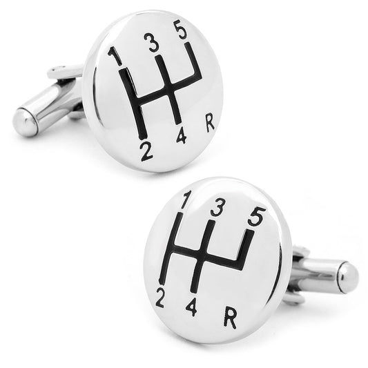 Pair of silver cufflinks with gear shift design on a white background