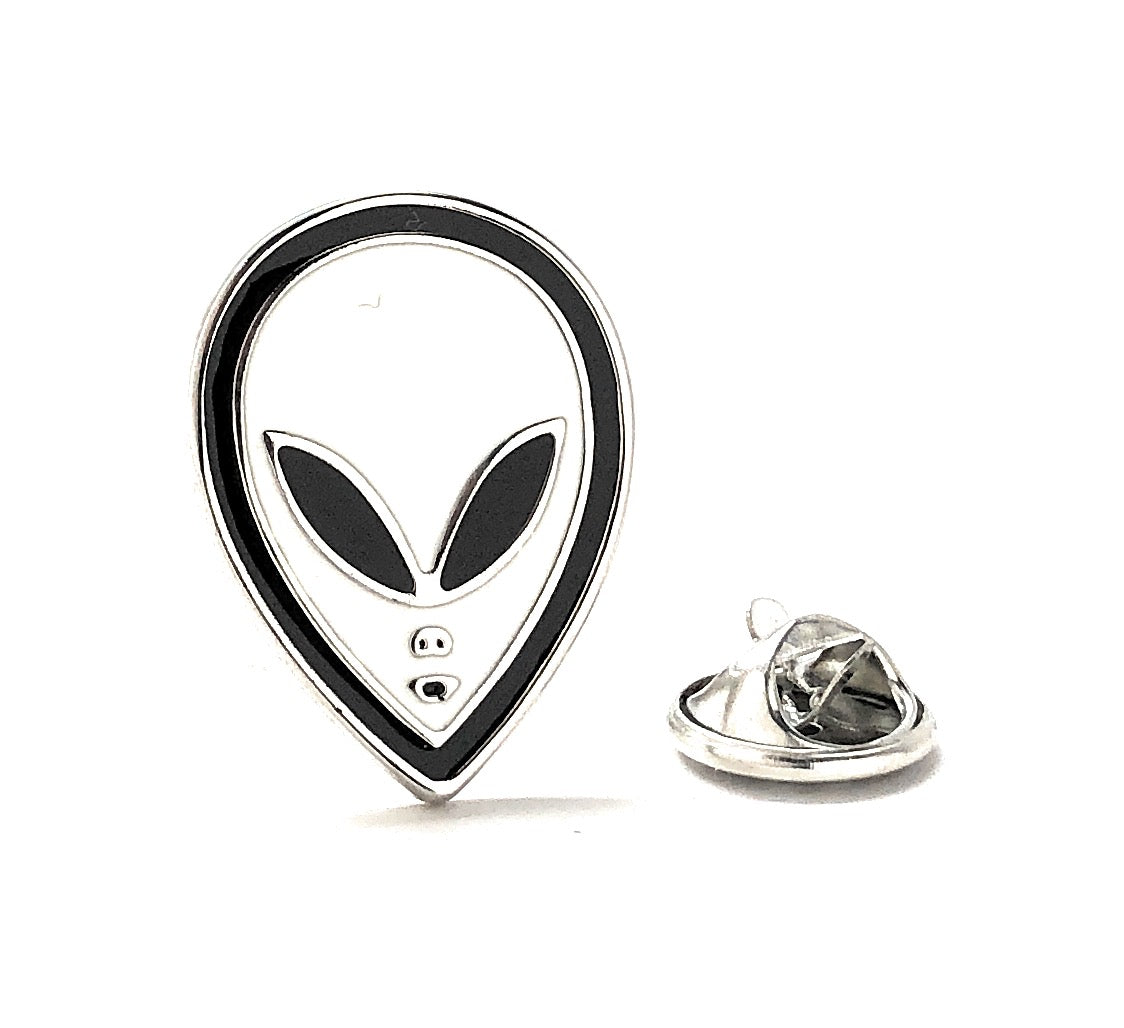 Alien head-shaped pin with a clear back on a white background