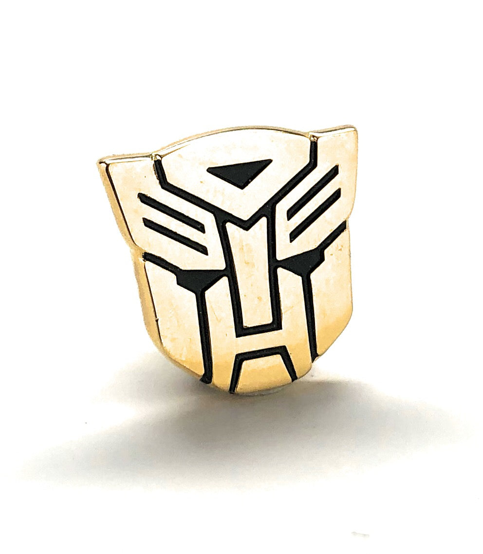 Gold Transformers robot emblem lapel pin with black detailing and gold clutch backing.