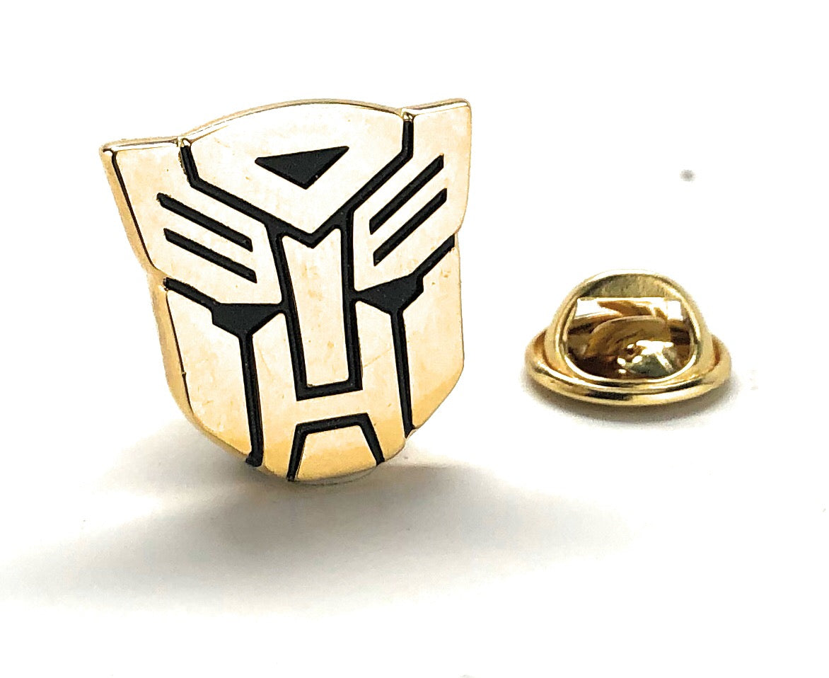 Gold Transformers robot emblem lapel pin with black detailing and gold clutch backing.