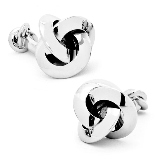 Pair of silver knot cufflinks on a white background