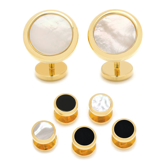 Set of gold cufflinks with white and black stone centers on a white background