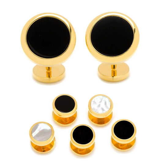 Set of gold and black cufflinks on a white background