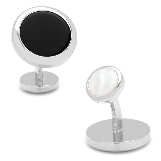 Two cufflinks with one black and one white round stone on a white background
