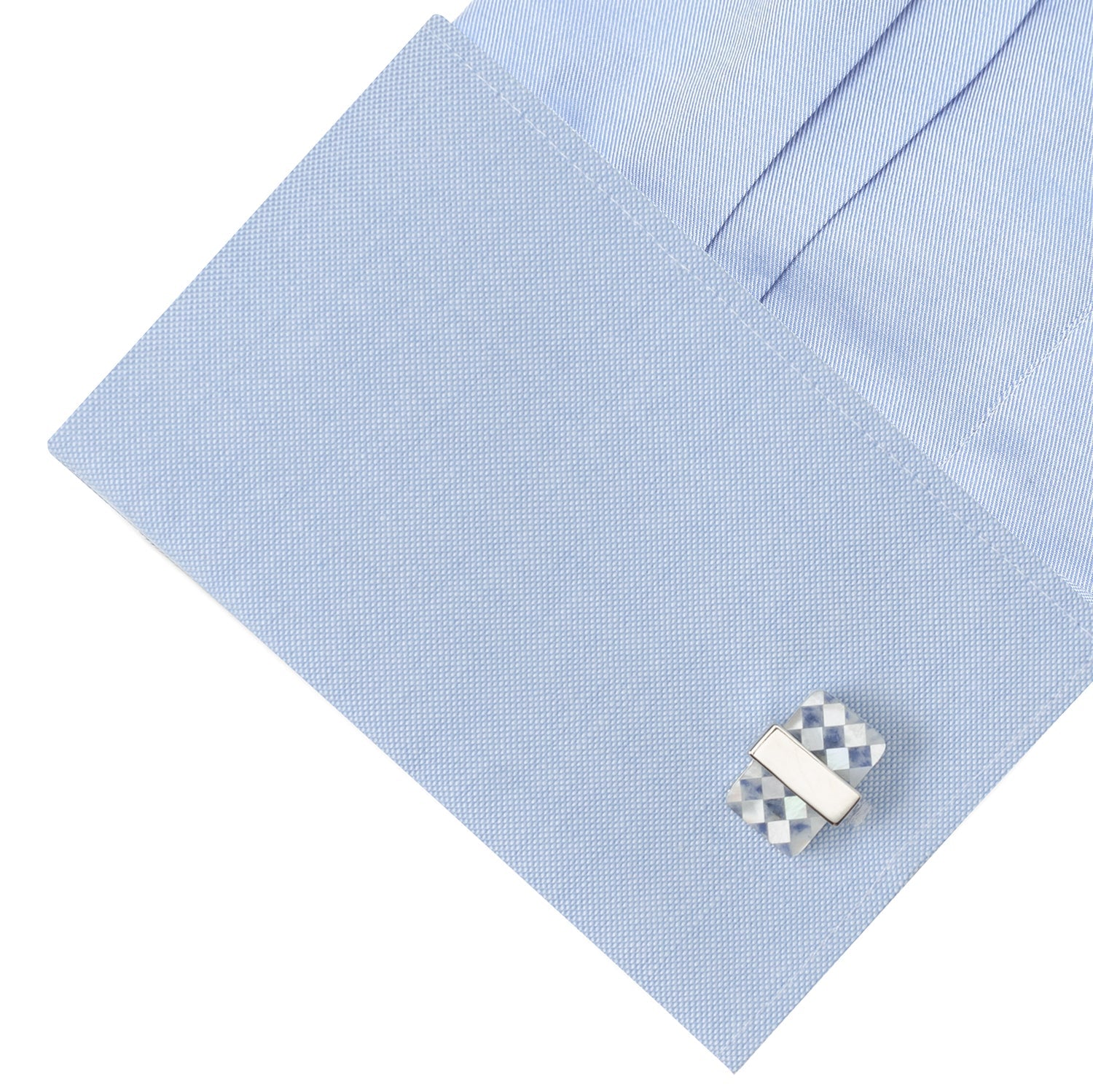 Cufflink on a light blue dress shirt
