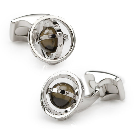 Silver cufflinks with a central dark gemstone on a white background