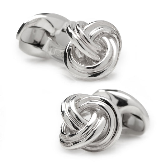 Silver knot-shaped cufflinks on a white background