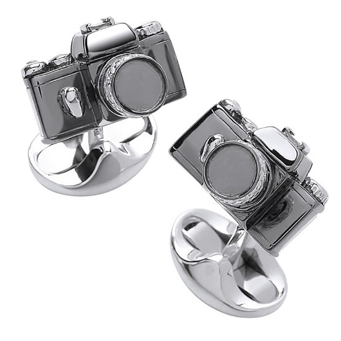 Camera-shaped silver rings on a white background