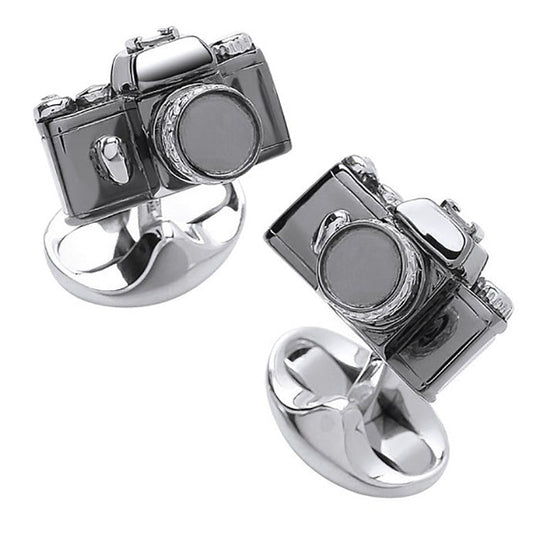Camera-shaped silver rings on a white background