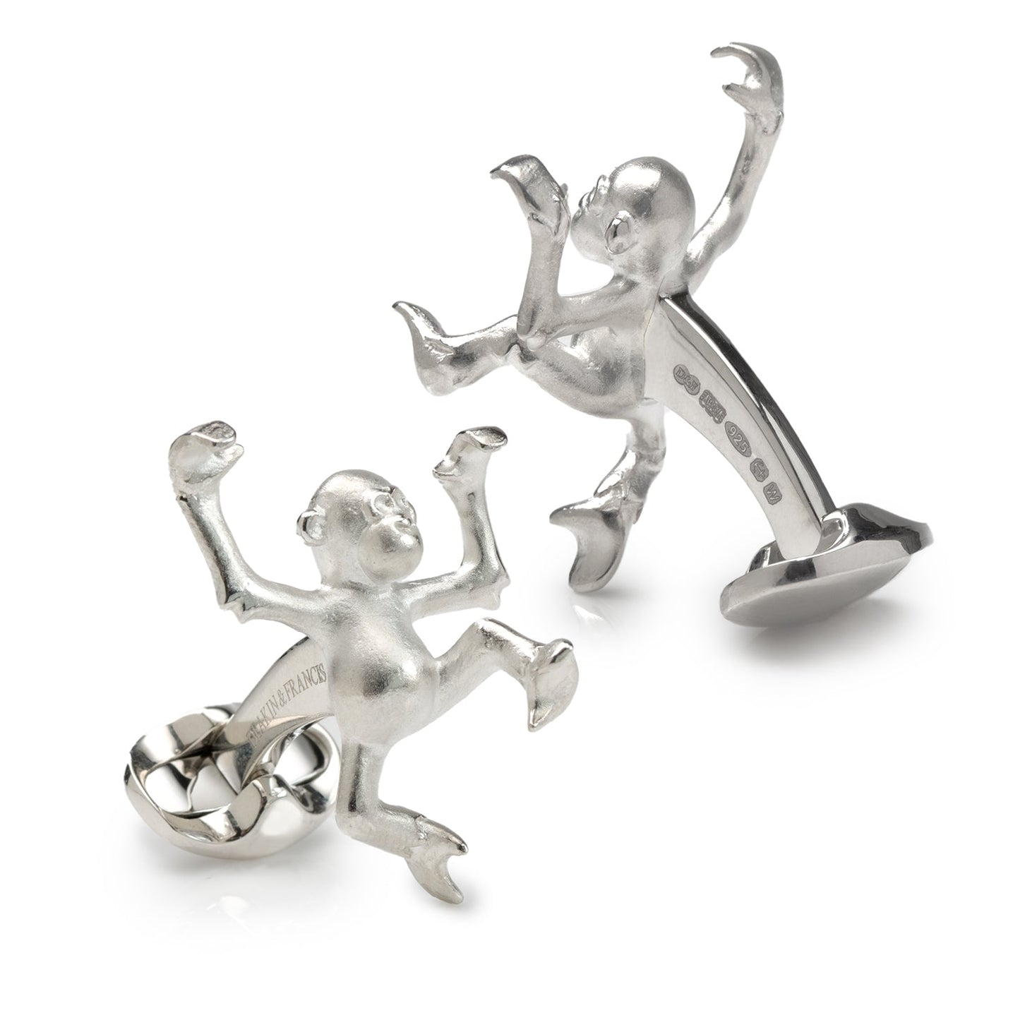 Silver monkey-shaped cufflinks on a white background
