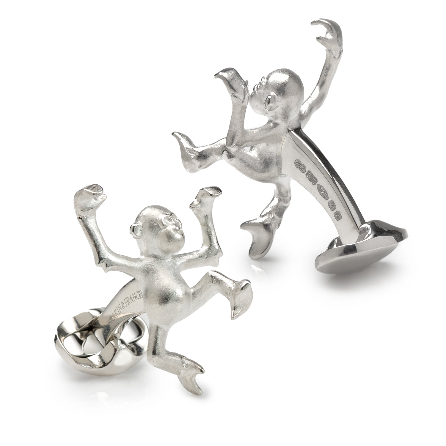 Silver monkey-shaped cufflinks on a white background