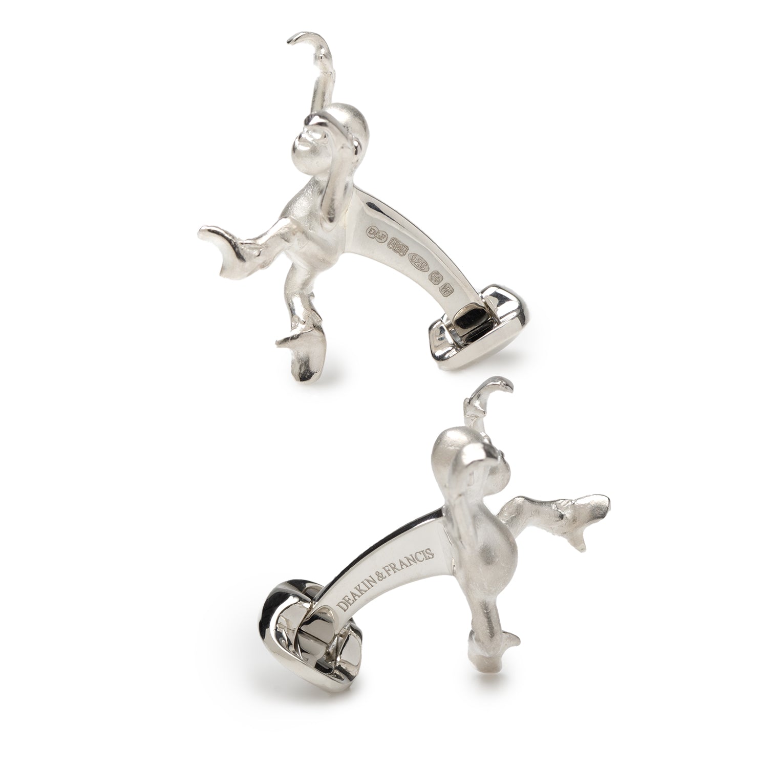 Silver monkey-shaped earrings on a white background