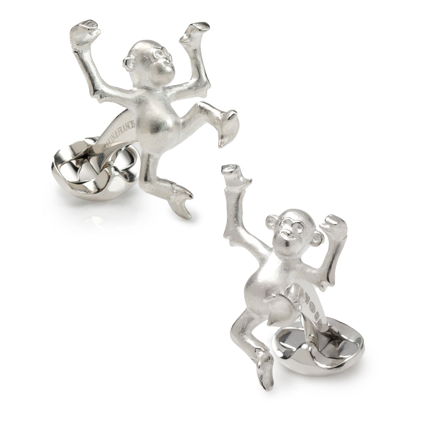 Silver monkey cufflinks on a white background
