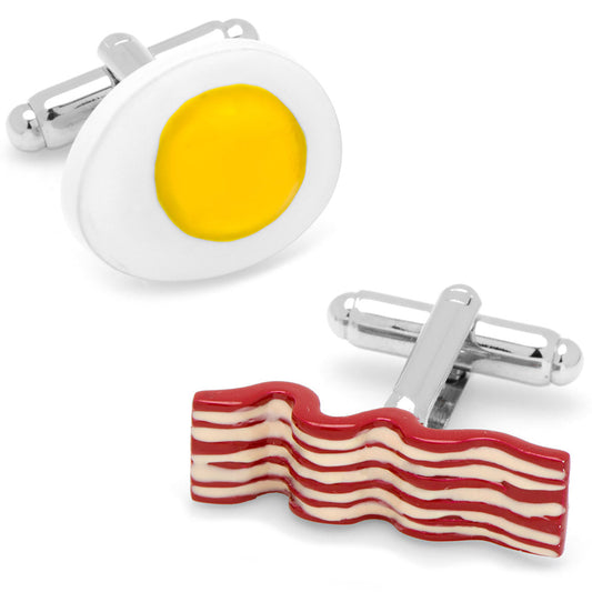 Cufflinks shaped like a fried egg and bacon on a white background