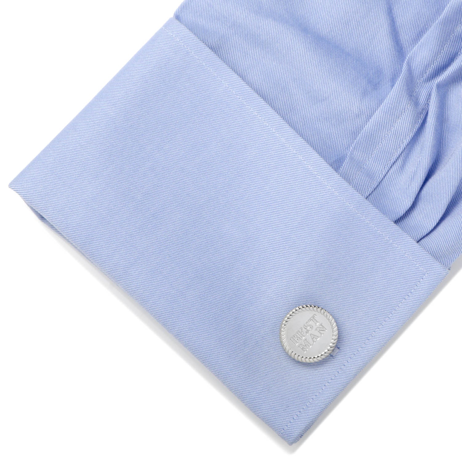 Close-up of a light blue shirt cuff with a silver cufflink on a white background
