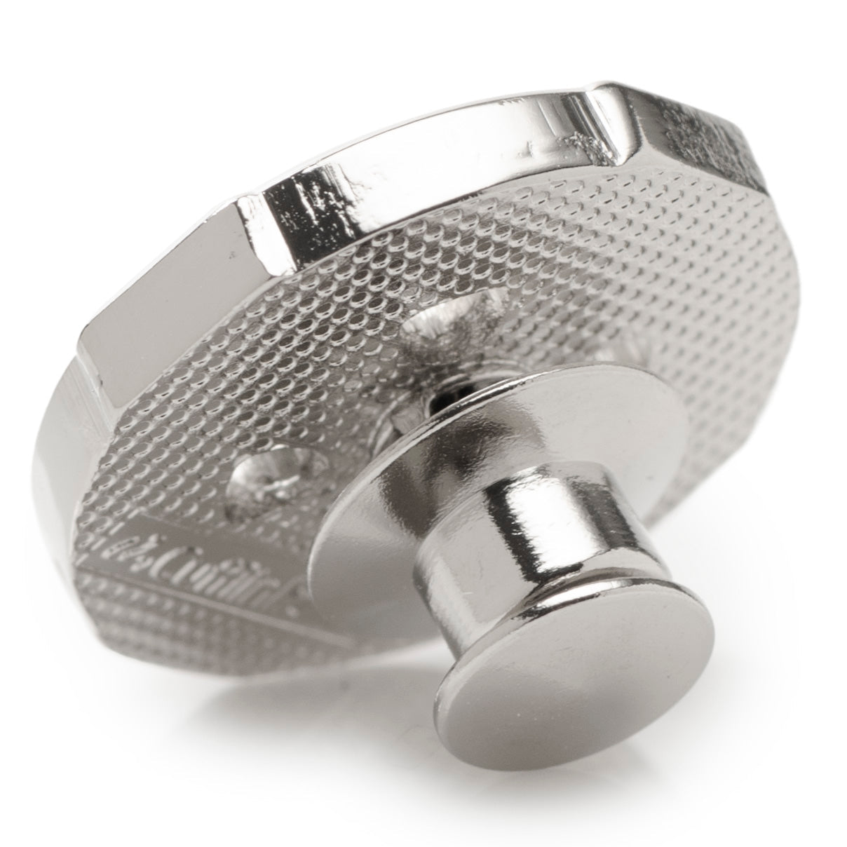 Metallic knob with textured surface on a white background