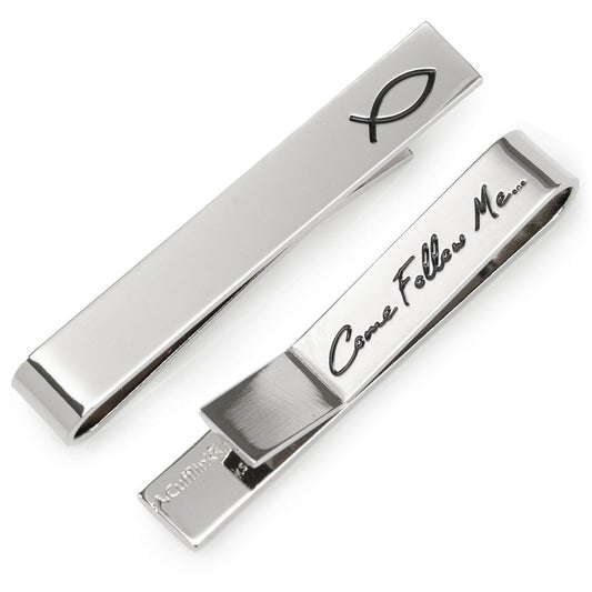 Silver tie clip with 'Come Follow Me' engraving and fish symbol on a white background