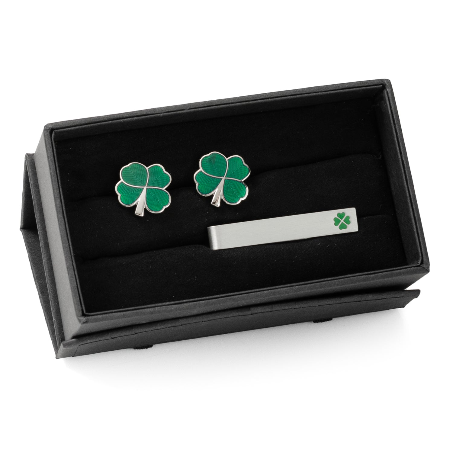 Four-leaf clover cufflinks and tie clip set in a black box on a white background