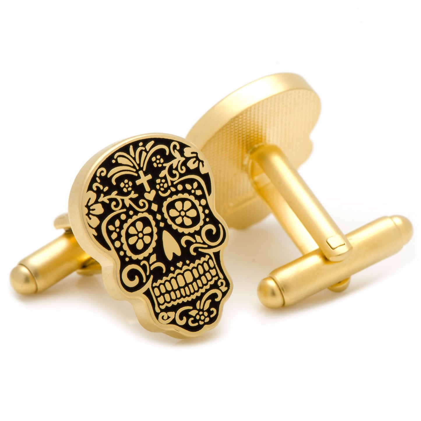 Gold skull cufflinks on a white background