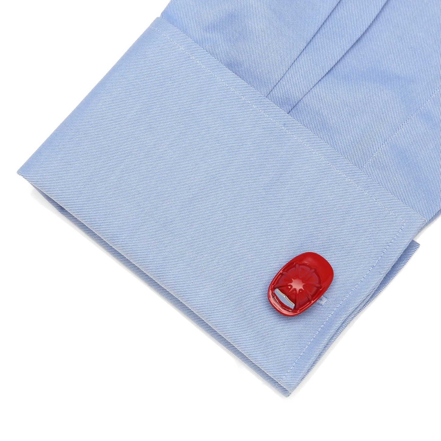 Red cufflink on a light blue shirt sleeve