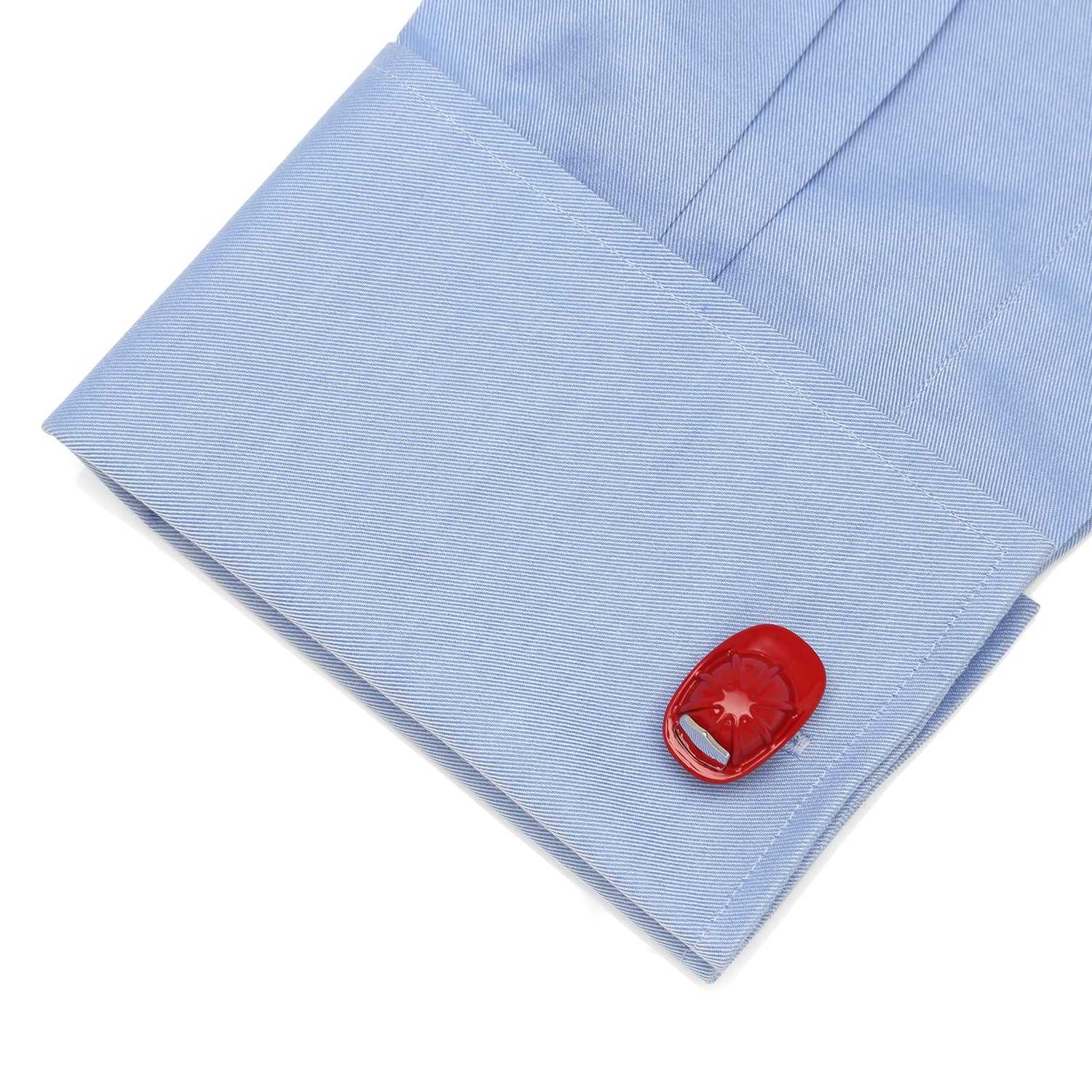 Red cufflink on a light blue shirt sleeve