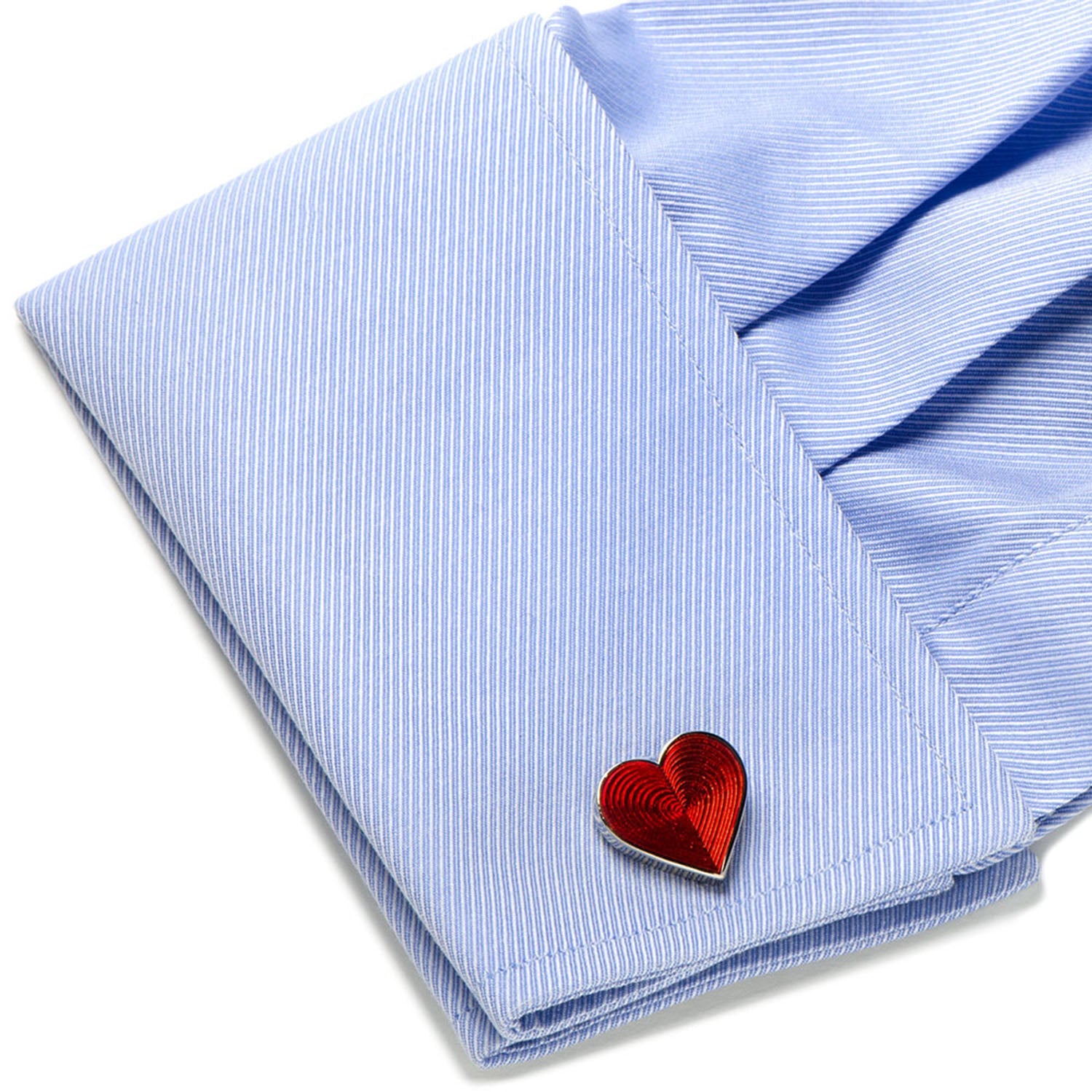 Red heart-shaped lapel pin on a light blue striped shirt