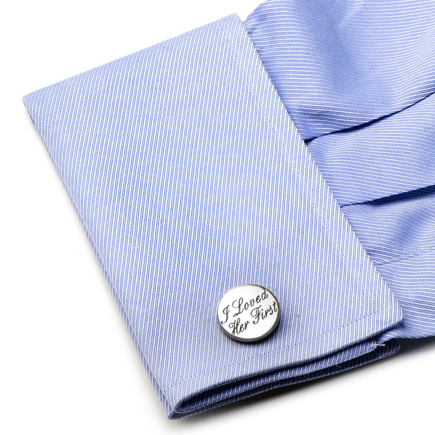 Close-up of a blue striped shirt cuff with a silver cufflink.