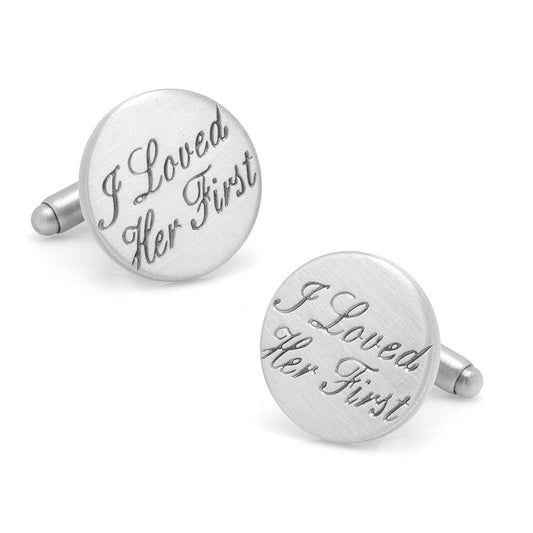 Silver cufflinks with engraved text on a white background