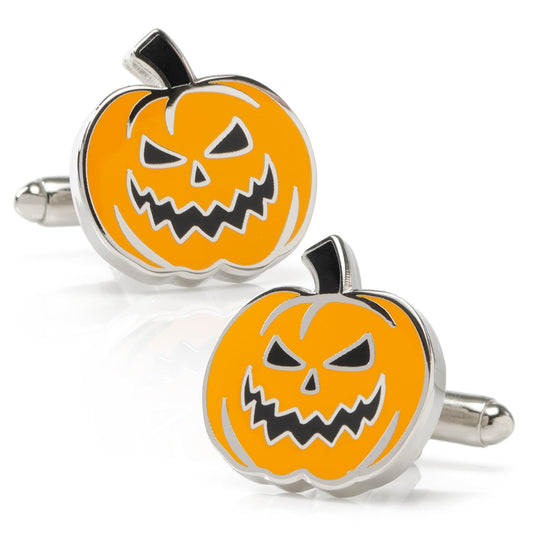 Pumpkin face cufflinks with silver borders on a white background