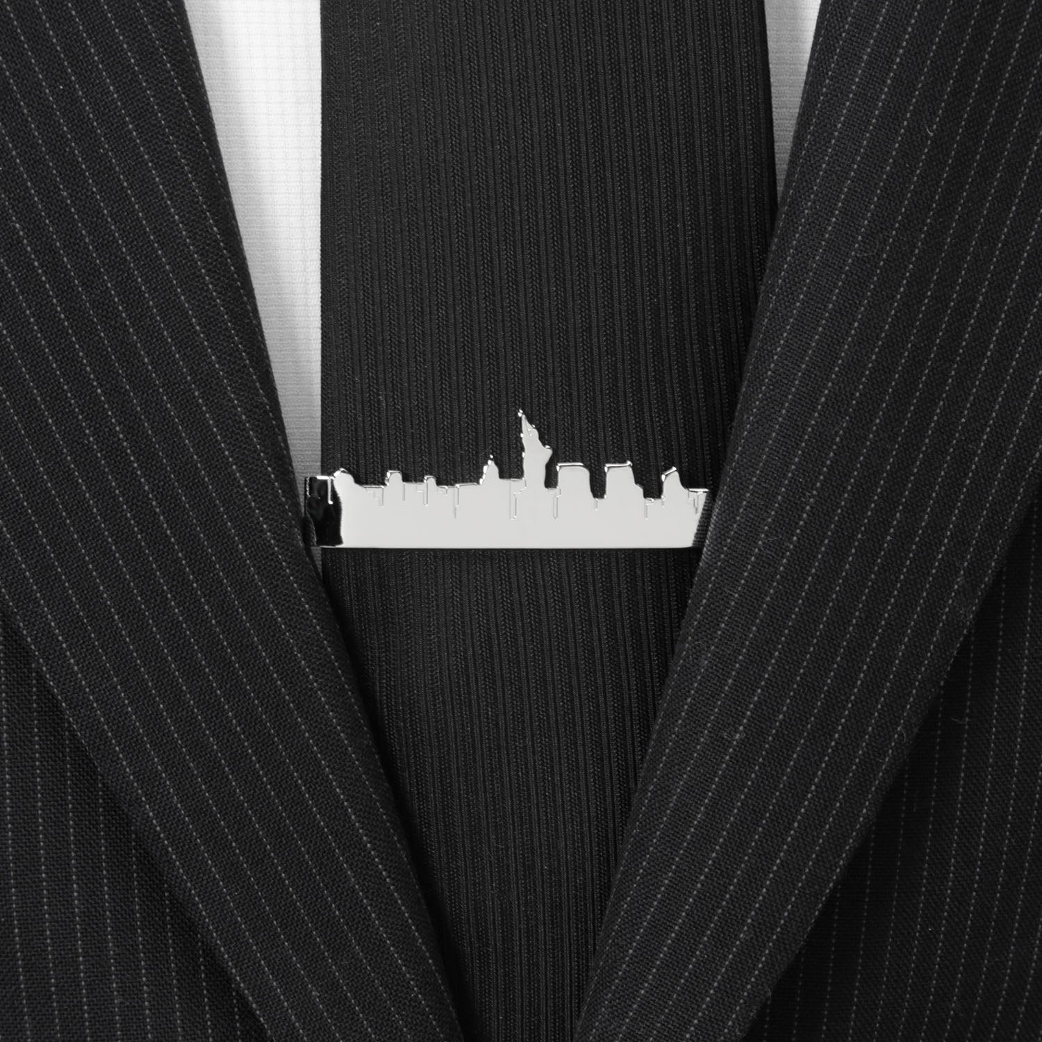 Black pinstripe suit with a silver tie clip featuring a city skyline.